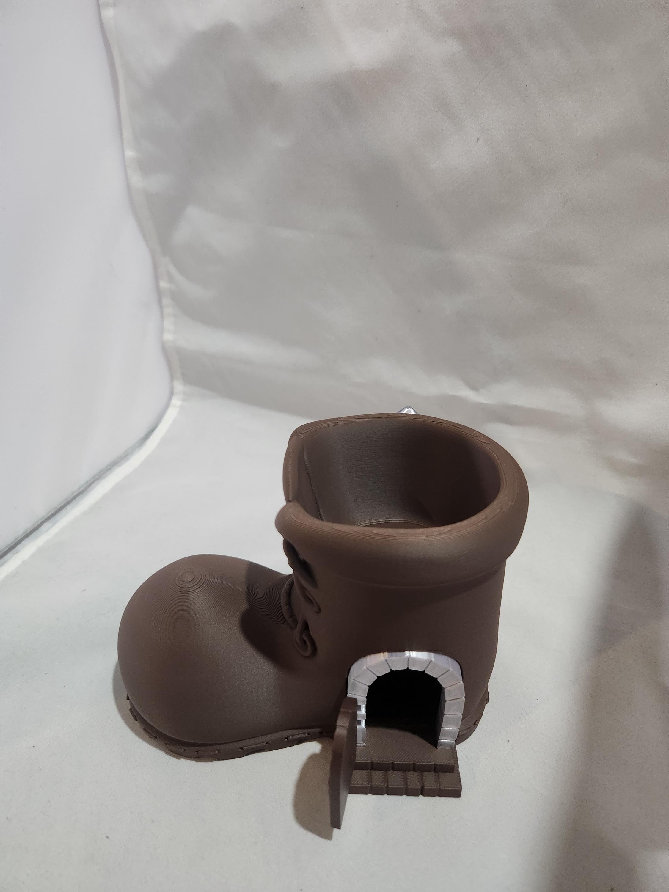 3D printed brown boot-shaped container with mini door and brick archway, tabletop decor