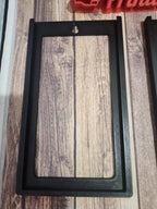 Black 3D printed rectangular frame with keyhole slot on wood surface
