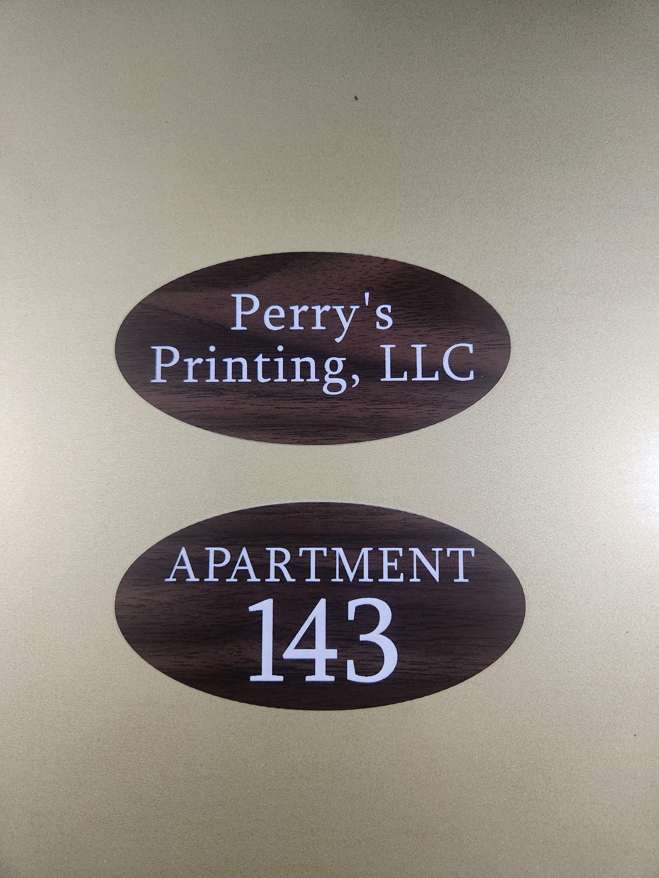 Custom oval wood-look signs with white text for apartment number and business name