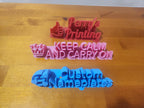 3D printed custom nameplates with text and icons on a wooden table, colorful personalized signage