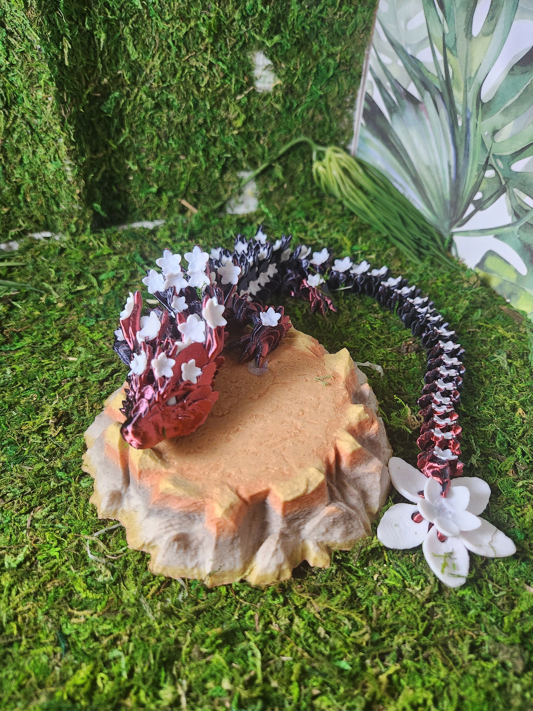 3D printed fantasy lizard with white flowers on a mossy base, nature-themed decor