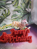 3D printed Perry's Printing red sign with thumb up, colorful leopard figure, leafy backdrop