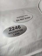 Custom engraved oval metal signs with room number and employees only text on white background