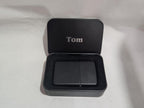 Custom engraved black lighter in a personalized metal gift box with 'Tom' inscription.