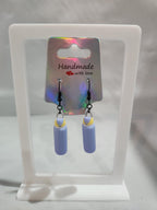 Handmade lavender water bottle dangle earrings on iridescent card display