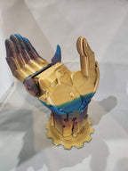 Rainbow metallic 3D printed mechanical hand on gear-shaped base, detailed and futuristic design