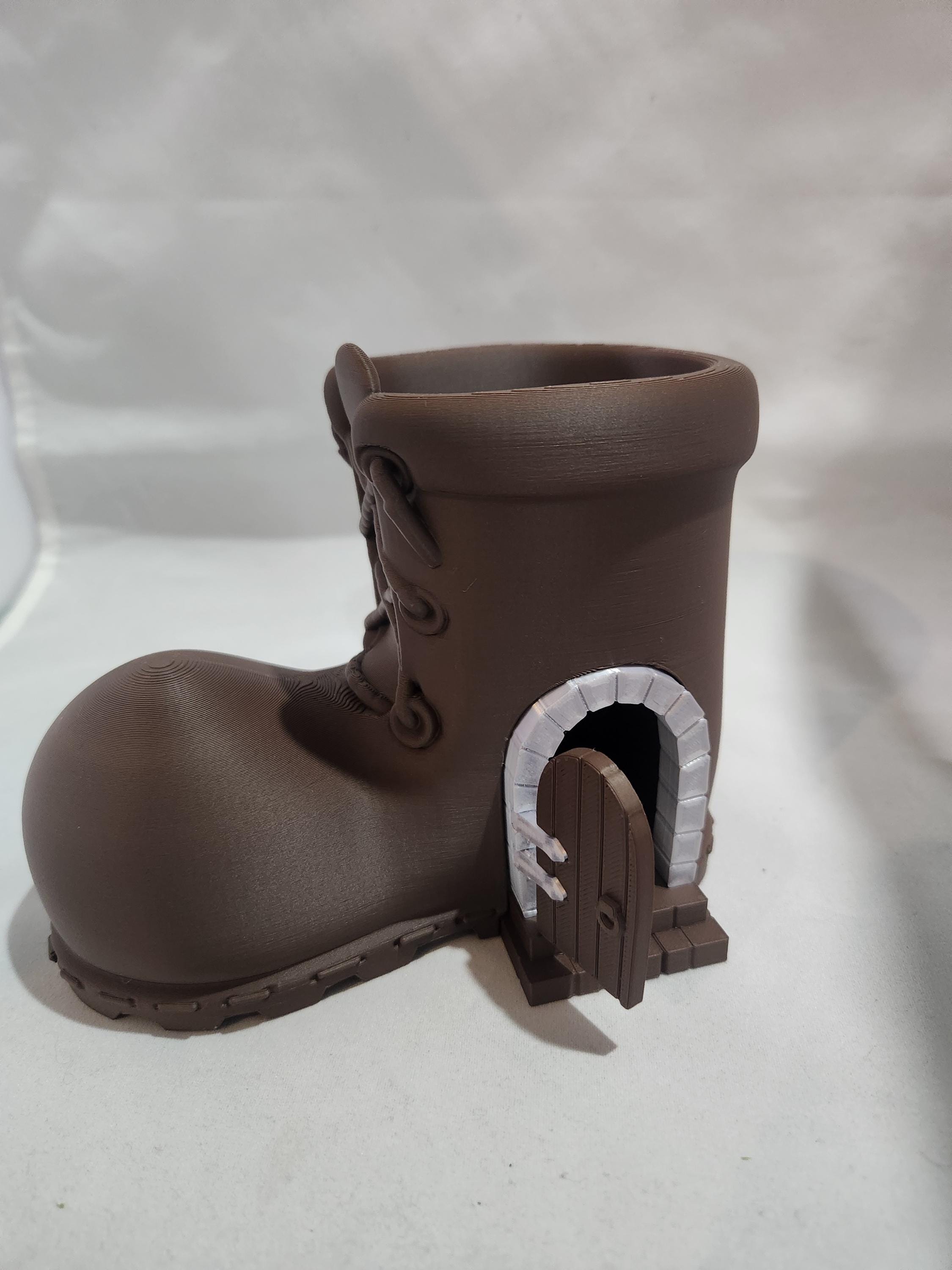3D printed brown boot planter with miniature arched door, whimsical home decor