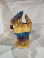 Multicolored 3D printed robotic hand sculpture with gold, blue, and purple gradient finish.