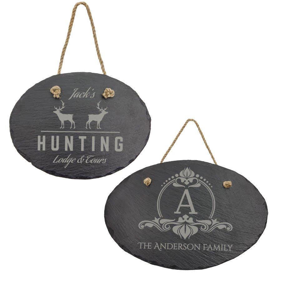 Custom engraved slate signs with rope hangers, featuring personalized names and designs.