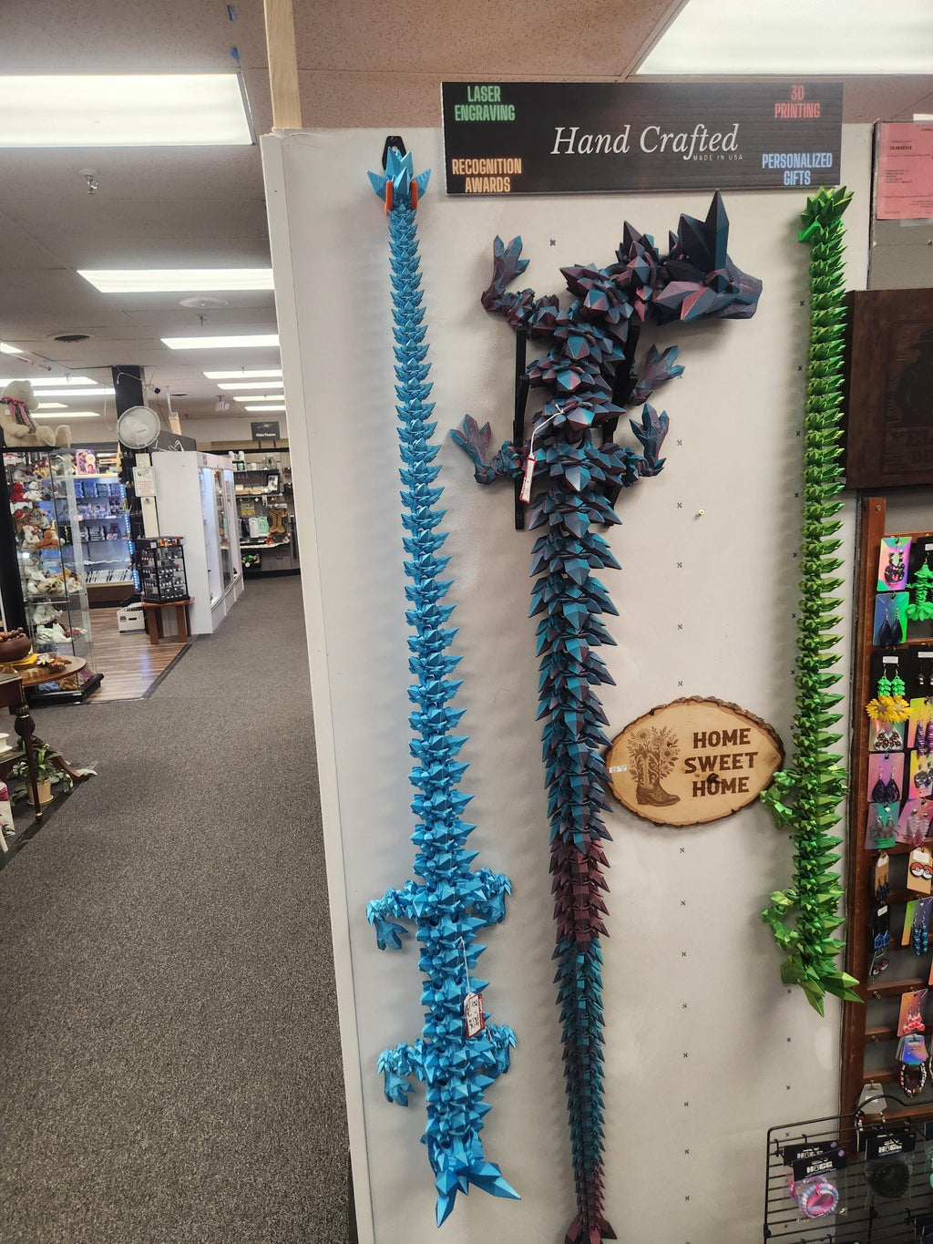3D printed geometric swords and dragon head wall decor, handcrafted and displayed in gift shop