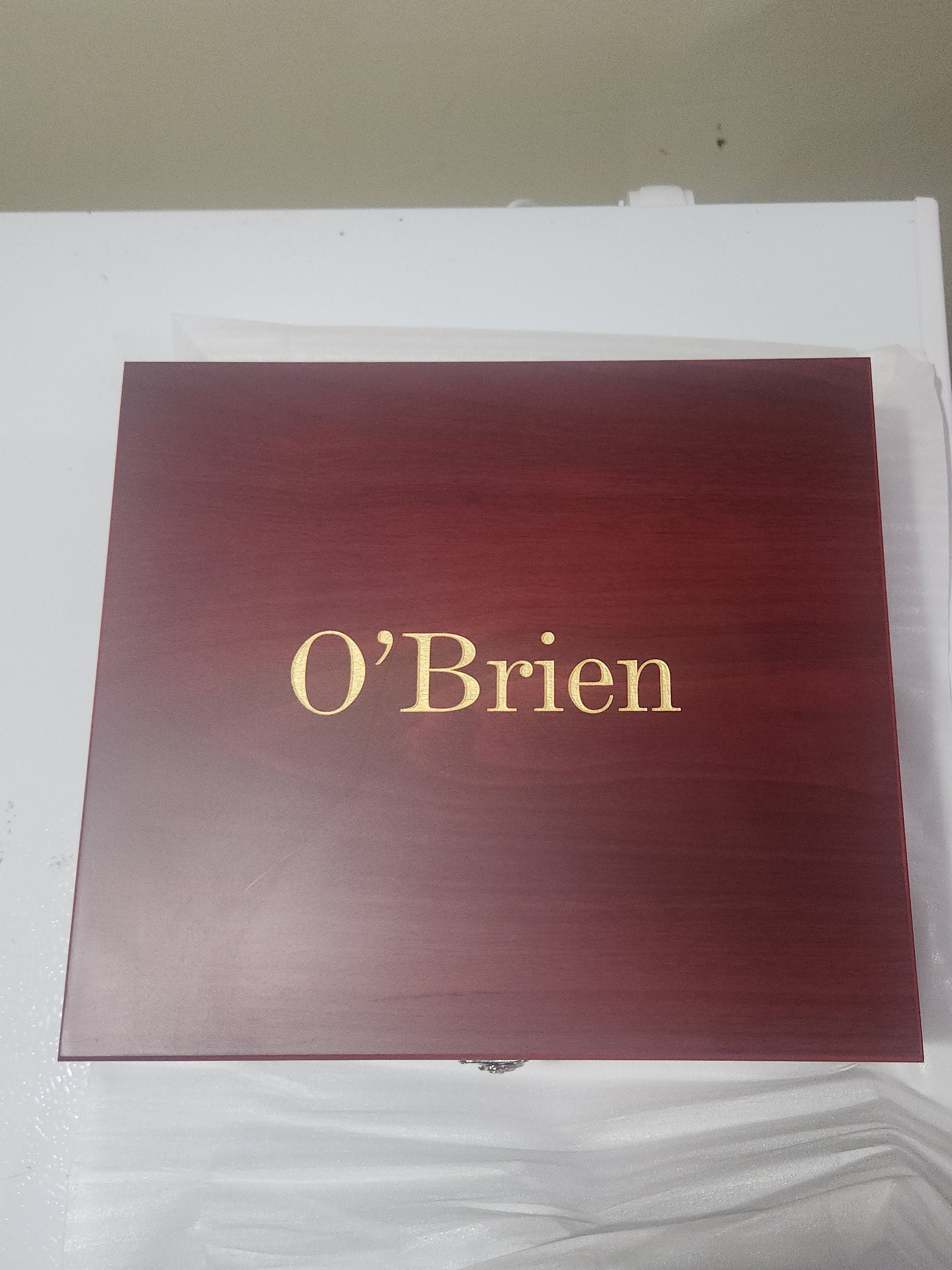 Custom engraved wooden box with O'Brien in gold lettering on the lid